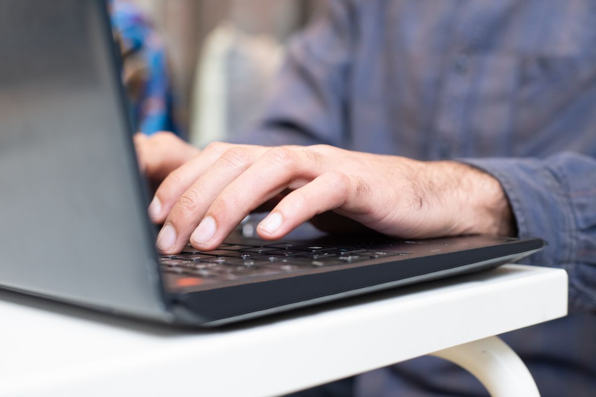 Customer using AI search optimization to find a local service business on a laptop