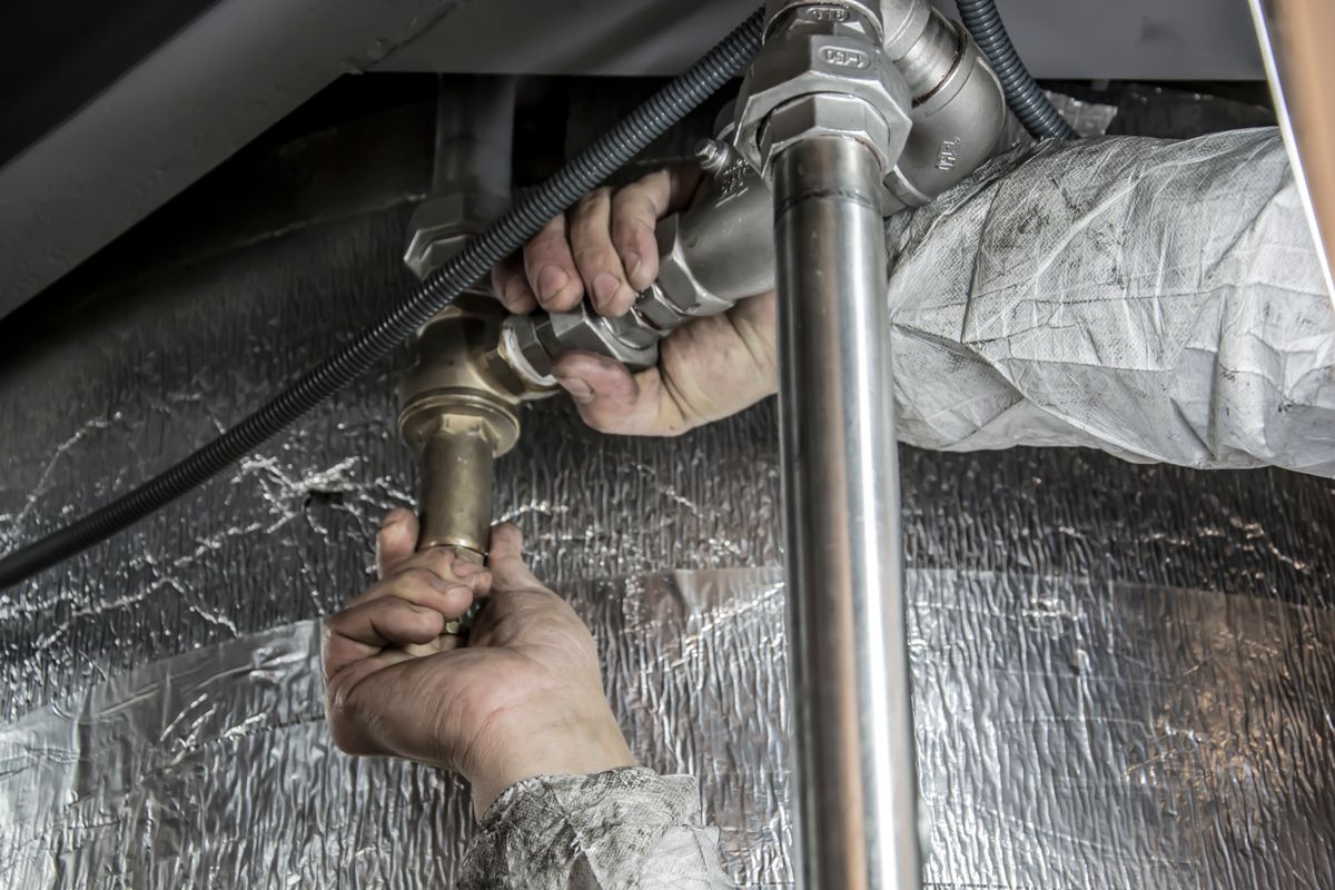 Contractor installing pipe fittings on a real service job