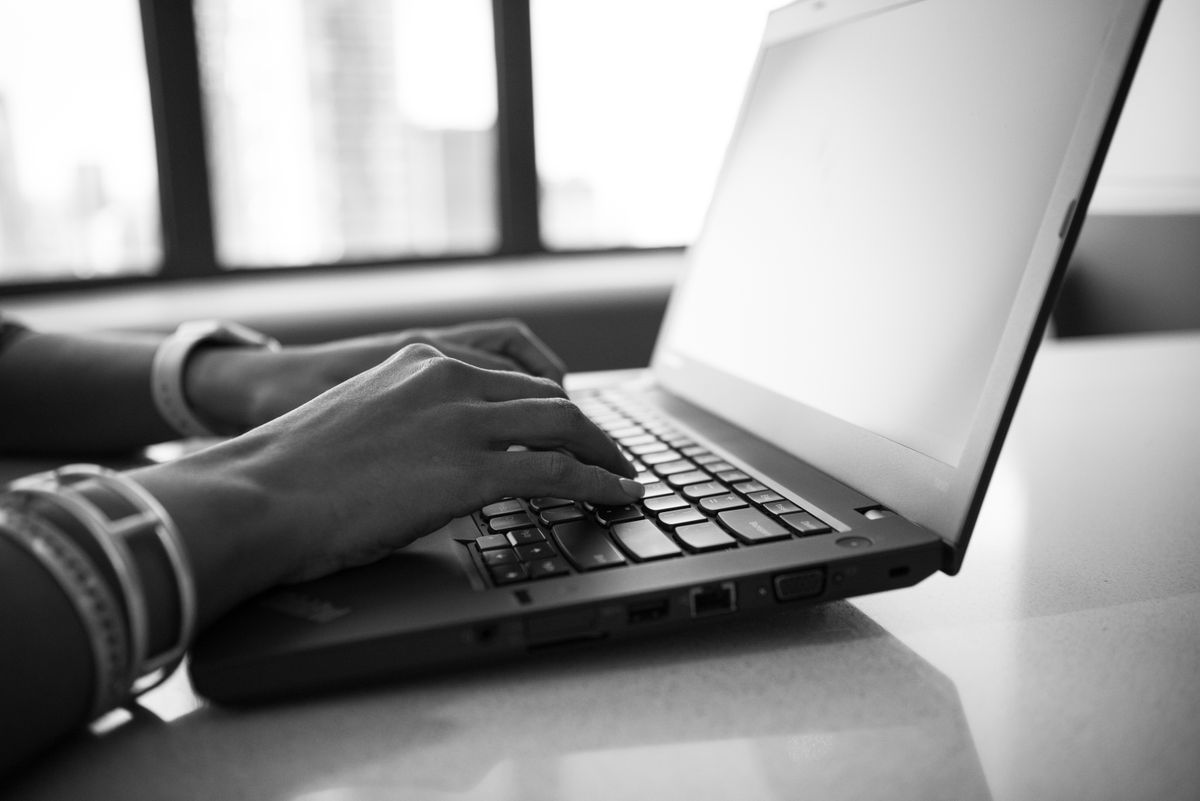 Hands typing a service query, the moment AI search optimization decides who gets recommended