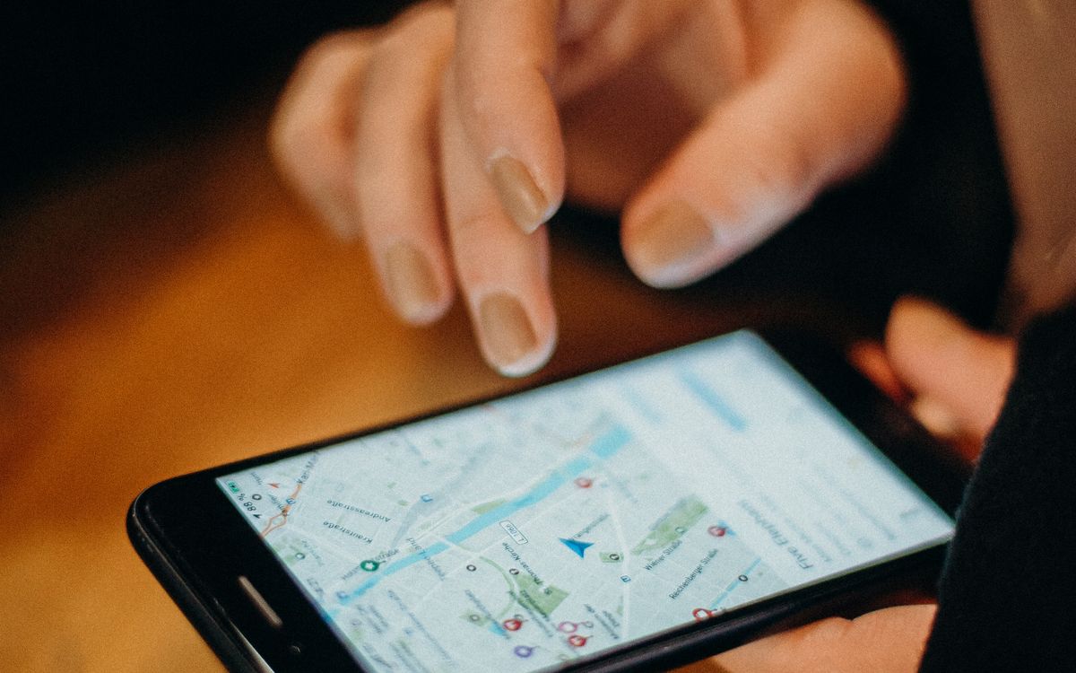 Homeowner using local search marketing results to find a home service business on a phone map