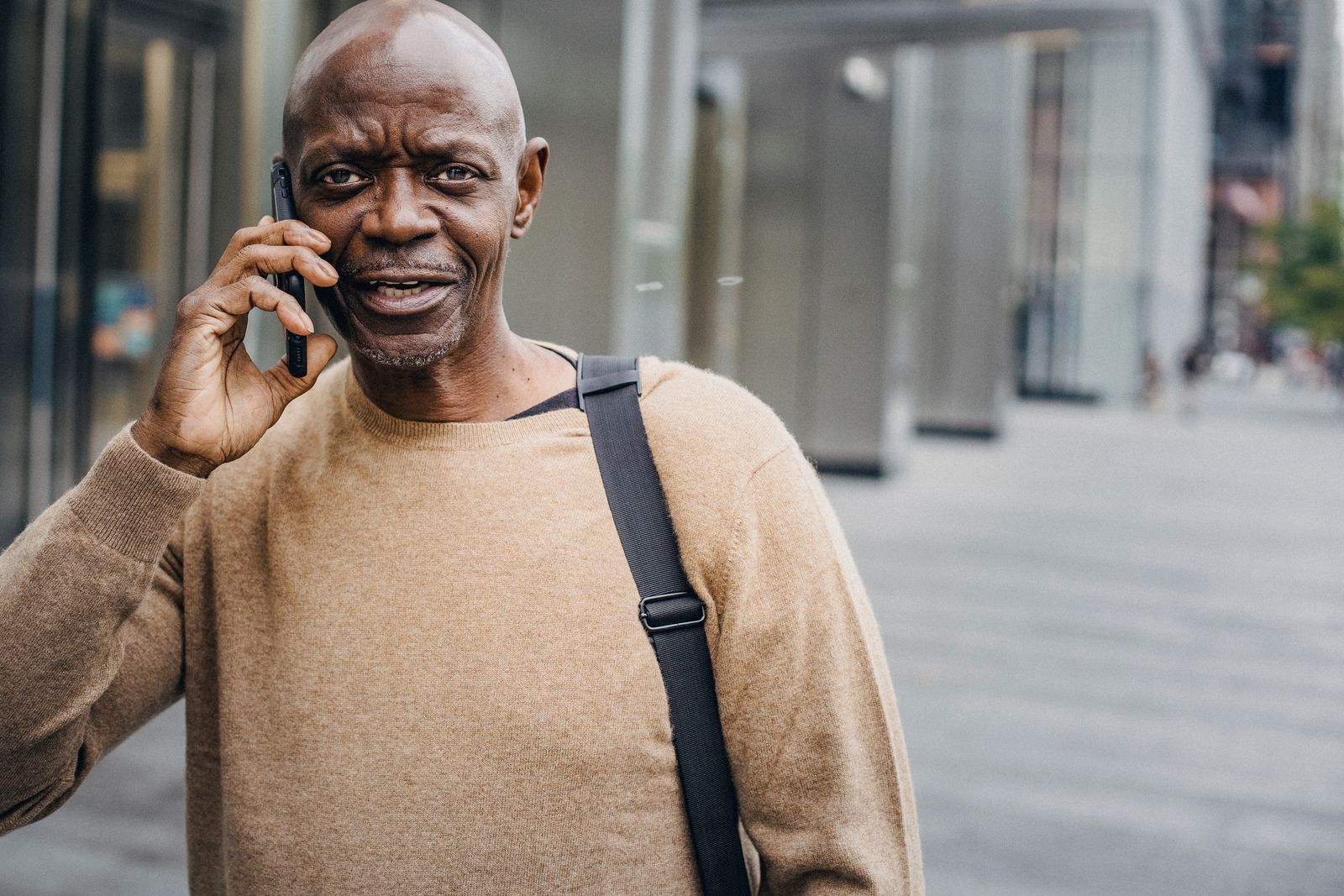 Local service business owner improving lead response time by answering a customer call on his phone