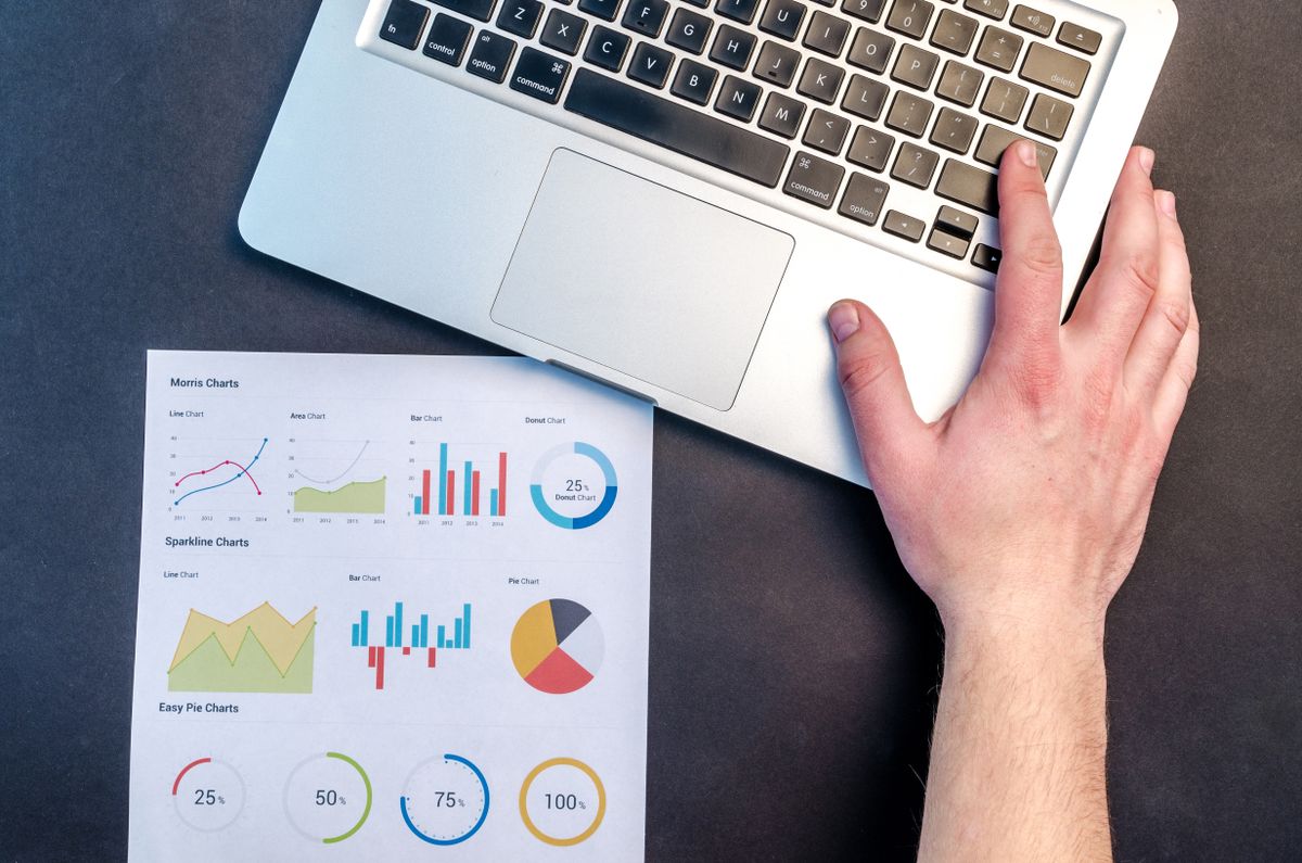 Laptop and marketing charts showing how to fix meta ads mistakes for local service businesses