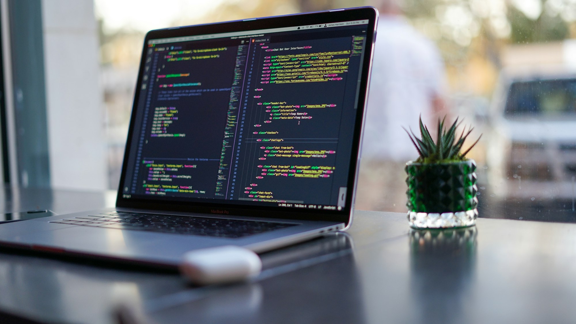 Laptop showing the site code where schema markup for local business is added