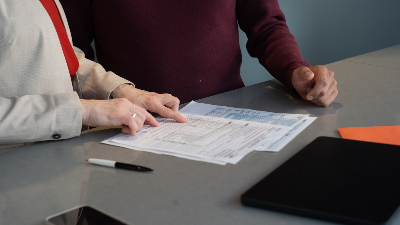 Business owner reviewing a marketing agency proposal and scope of work at a conference table