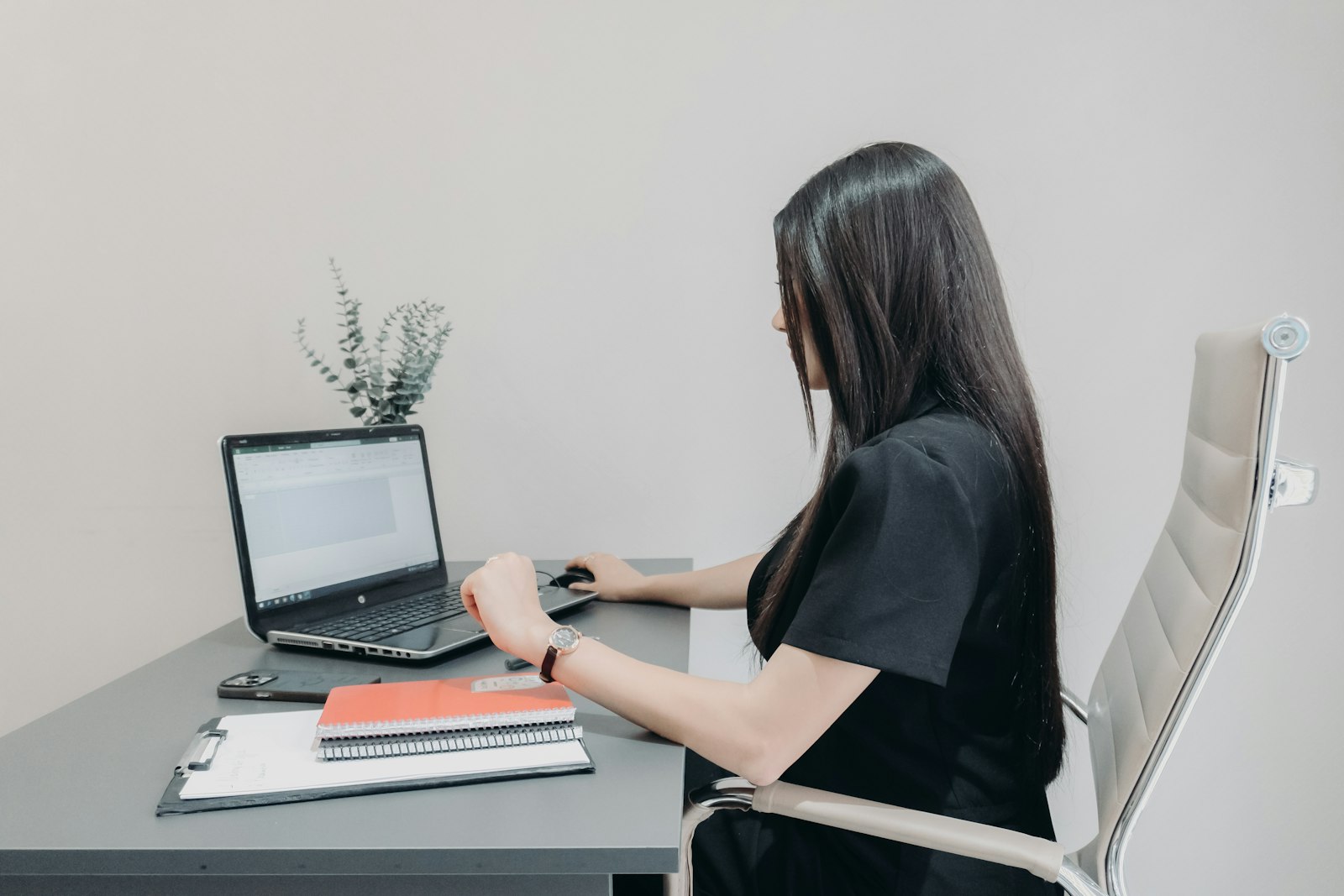 Business owner at a laptop cleaning up a customer list before a database reactivation campaign