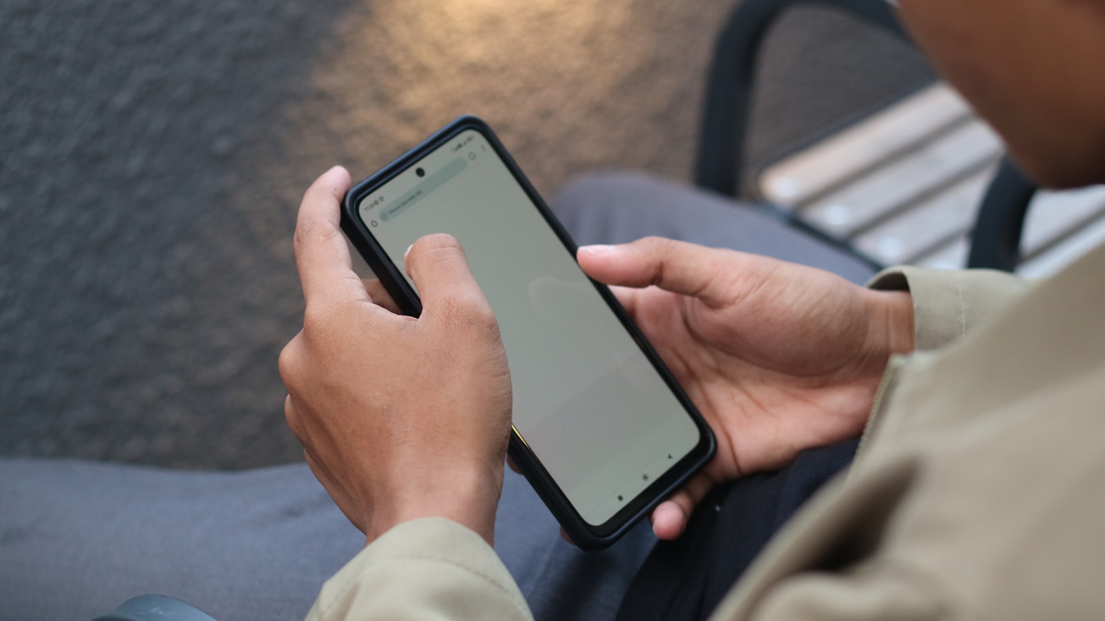 Close view of hands navigating a phone screen while comparing local contractors