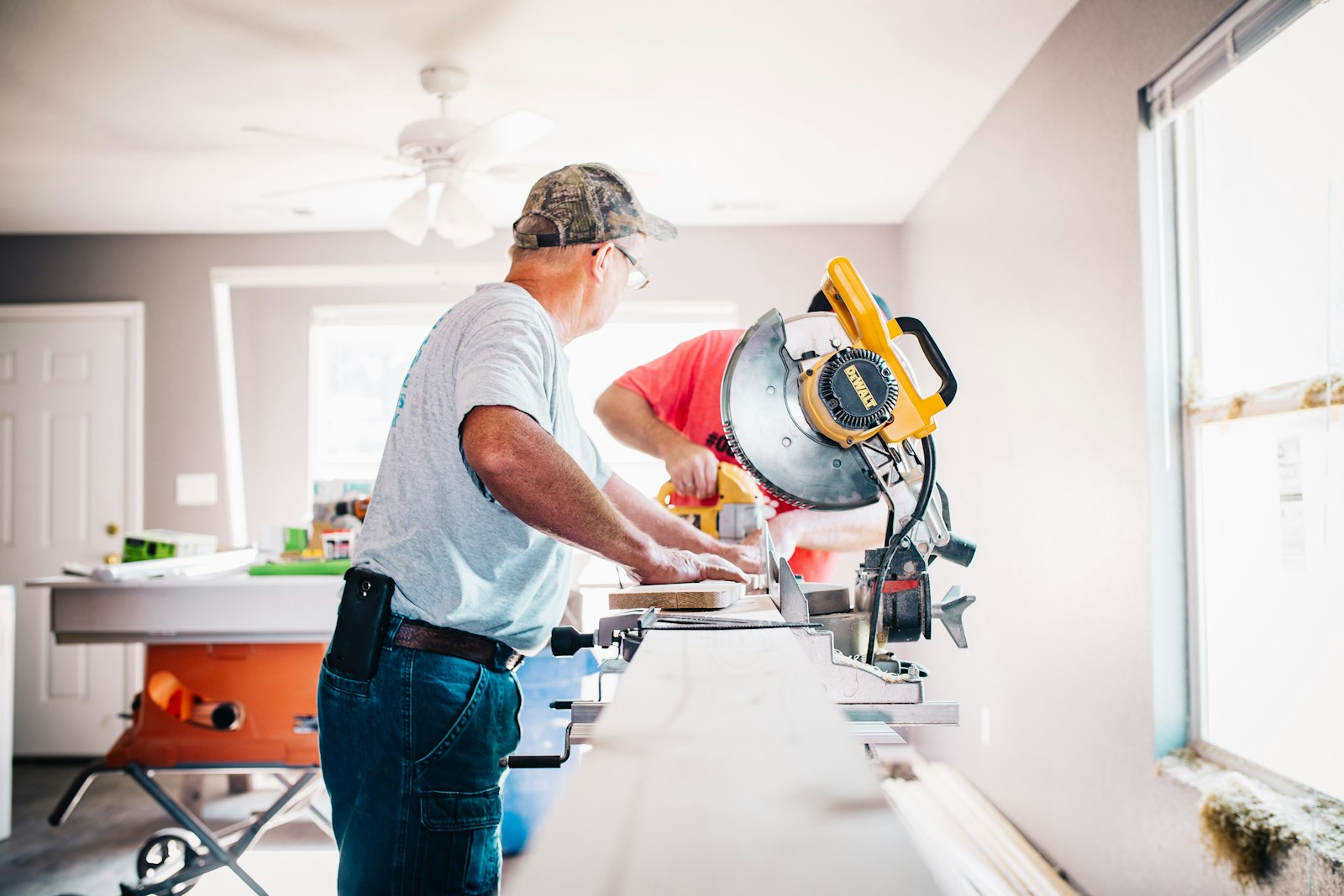 Owner of a new service business working at a saw in his shop