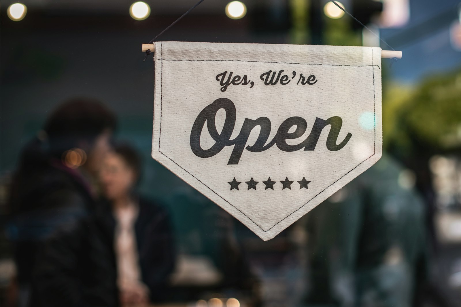 Open sign in a window on the day a new service business starts taking calls