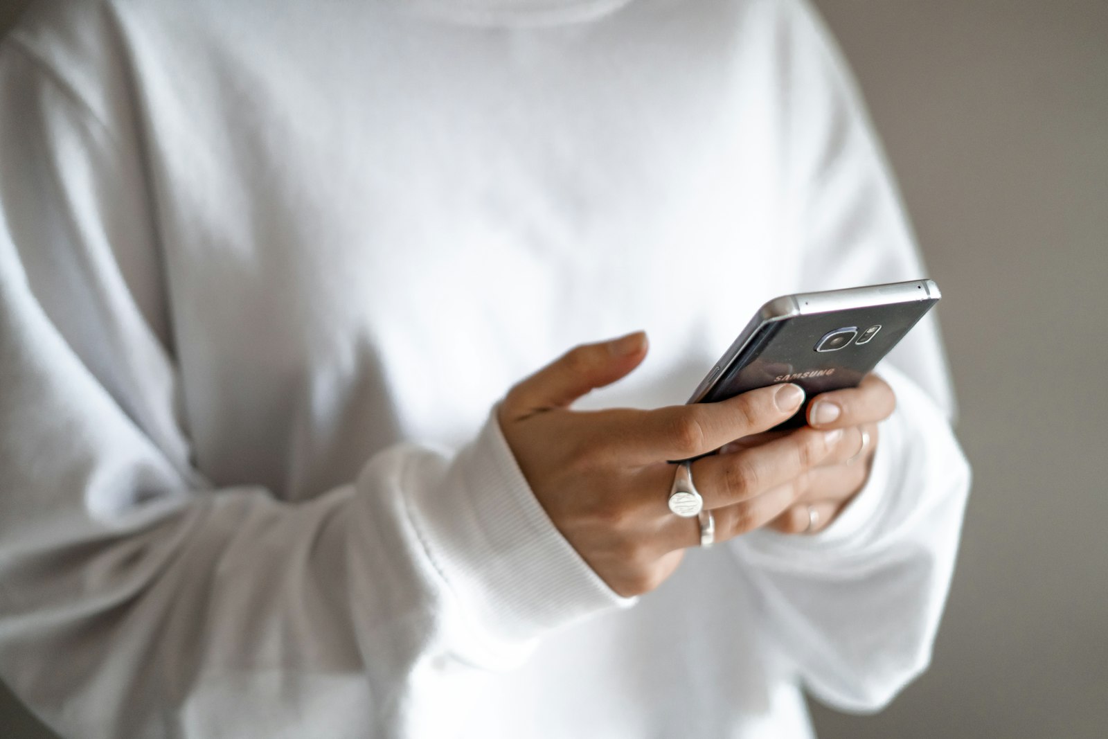 Past customer reading a text message from a service company on a smartphone