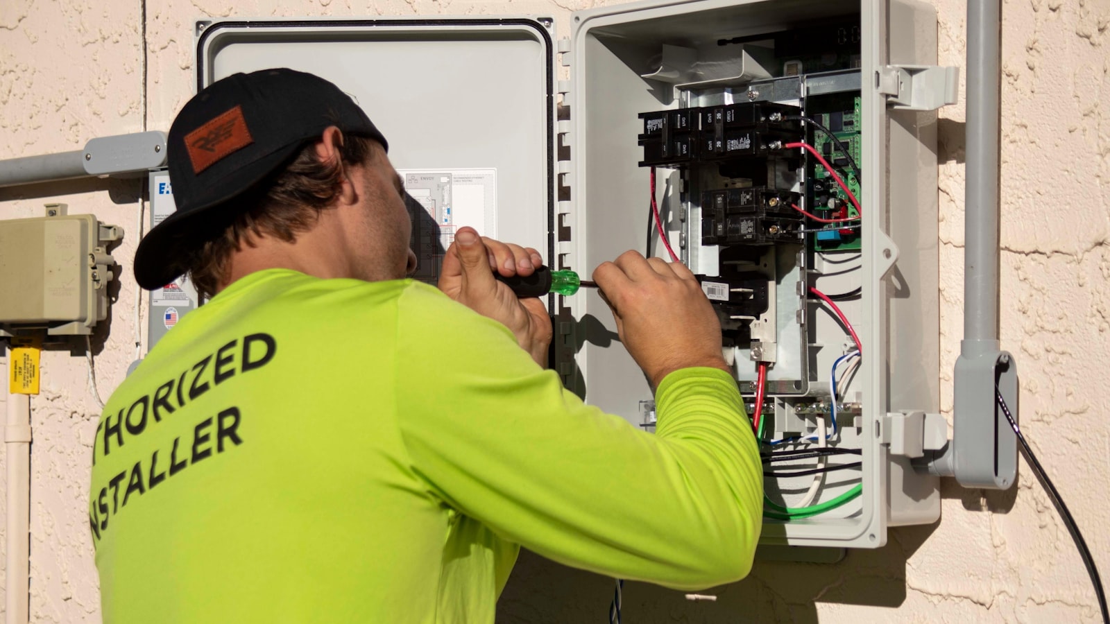 Service technician wiring an outdoor electrical panel on a job booked through a paid ad