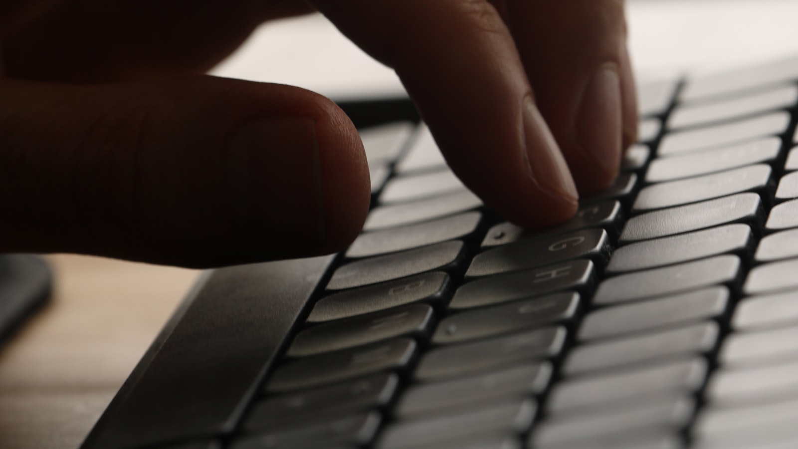 Writing ad copy that books jobs for a local service business on a laptop keyboard