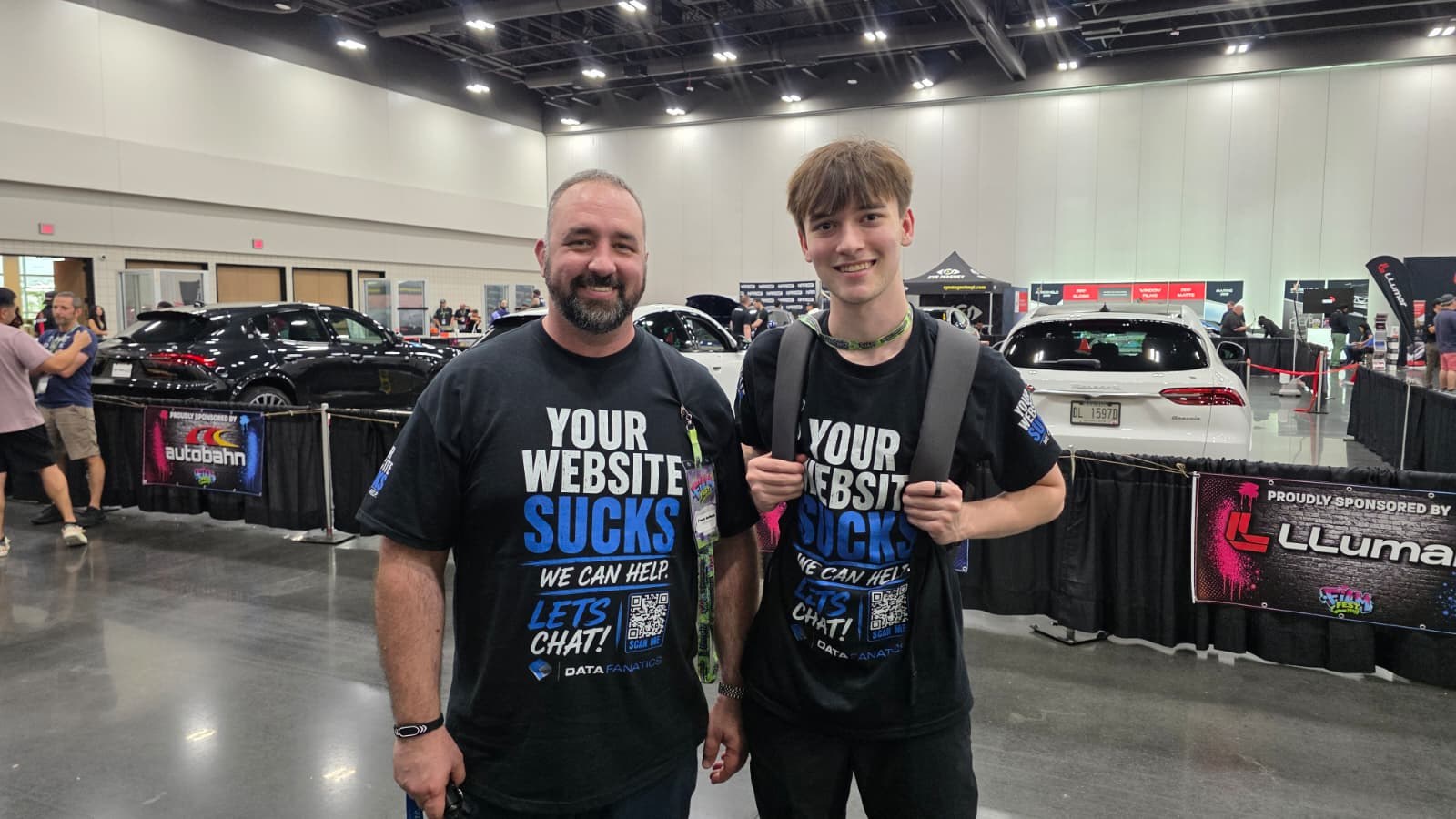 Brady and Frank Collette in Data Fanatics shirts at a trade show